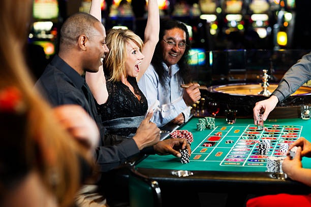 Multi-camera view of Monopoly Live studio showing host, wheel, and betting interface